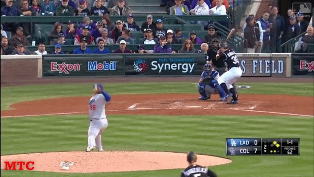 Baseball pitcher catching a ball.